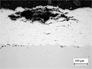 Fig. 12. Cross section through coating after exposure to test solution for 20 hours to illustrate corrosion along inter-particle boundaries