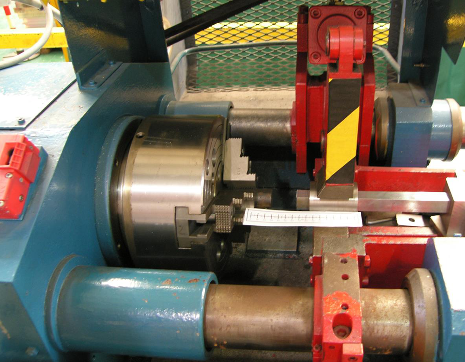 Figure 14 Set-up for friction welding round bar onto the end of square section SENT blanks, which were held in a custom-made holder for the specimen dimensions.