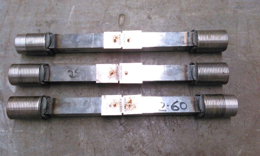 Fig. 5 Friction welded threaded end SENT specimens, shown with shims attached to the notch mouth ready for the screw attachment of a double clip gauge before testing
