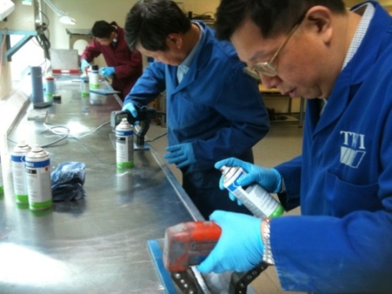 SOIC delegates experiment with dye penetrant testing.