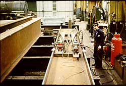 Local heating of the flange edges to produce curved beams for a bridge structure 