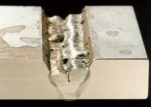 Fig. 2. The influence of welder technique on the risk of slag inclusions when welding with a basic MMA (E7018) electrode a) Poor (convex) weld bead profile resulted in pockets of slag being trapped between the weld runs
