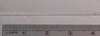 Figure7: Butt weld of 300μm thick sheets of aluminium alloy - Detail of top surface of a 2.0 mm width weld line 