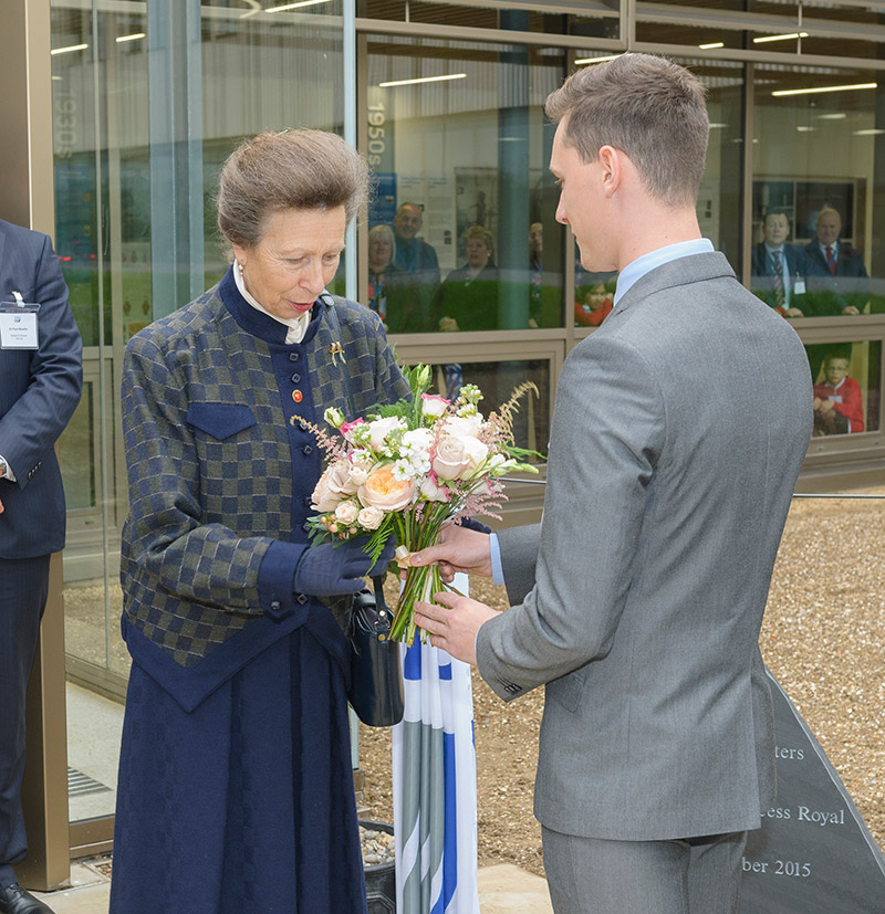 Her Royal Highness is presented with a bouquet by TWI advanced engineering apprentice Mr Alex Russell