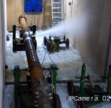 Figure 20. A thick-walled specimen on test in a TWI designed resonance fatigue test machine, located in TWI’s pressure pit test facility. Water can be seen escaping from a through-wall fatigue crack