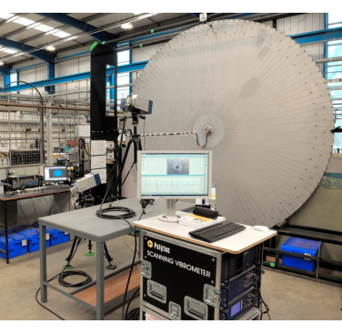 Figure 1. Test set-up - the prototype omnidirectional transducer, mounted at the centre of the plate, and the scanning vibrometer system, used to measure the ultrasound propagation, may be seen
