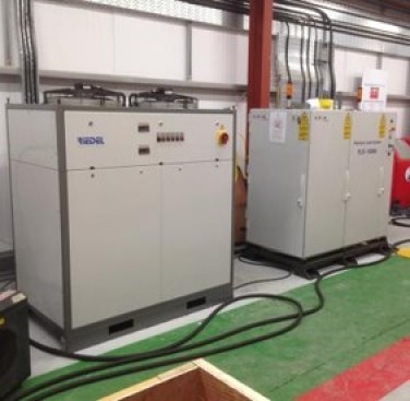 Figure 41. Installation of the laser (right) and its chiller (left) on site - after a 500-miles plus road-trip