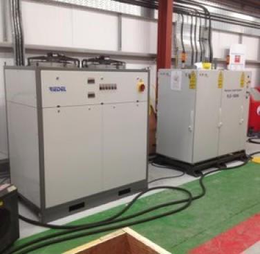 Figure 41. Installation of the laser (right) and its chiller (left) on site - after a 500-miles plus road-trip