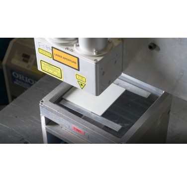 Figure 14. Overhead view of polybutylene terephthalate (PBT) coupon held under pressure, underneath laser welding head