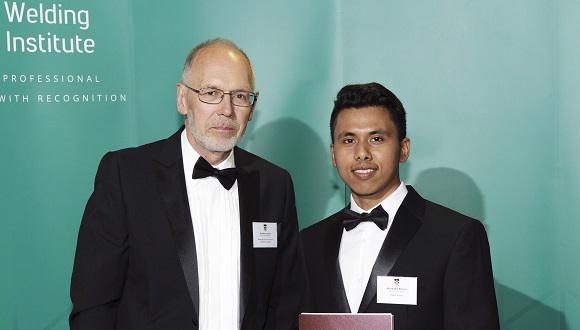 Dibakor Boruah receives his Armourers and Brasiers Best PhD Award from Mike Goulette