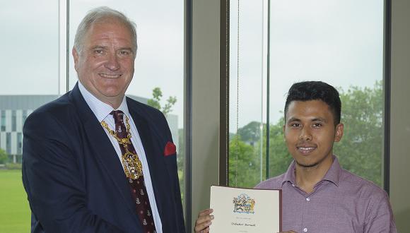 Dibakor Boruah presented with his Armourers and Brasiers Travel Award by Christopher Weston-Simons