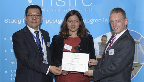 Aamna Asad (centre) receives her award
