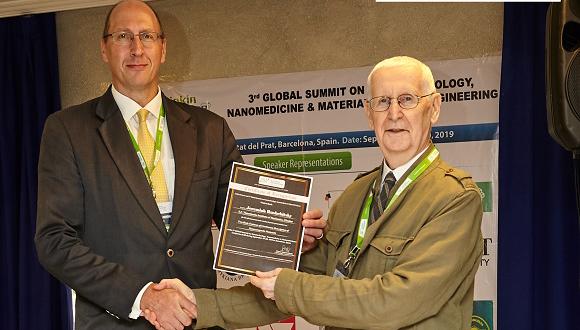 Chris Worrall (left) presenting an award to Professor Rushchitsky 