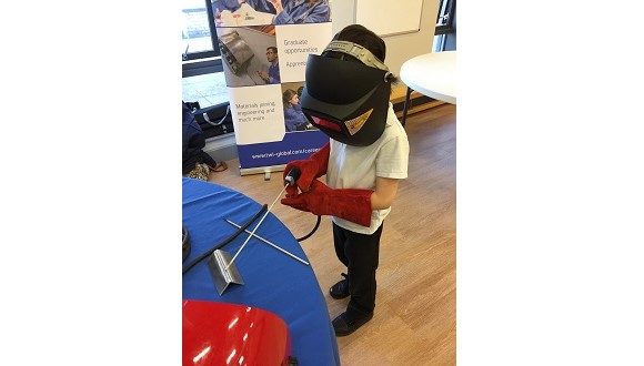 Jonas Moore simulates stick welding at Trumpington Meadows and Fawcett Primary School 