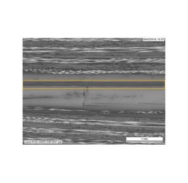 Figure 1. Sacrificial PEEK interlayer between two carbon/PEEK laminates. Yellow lines denote weld location