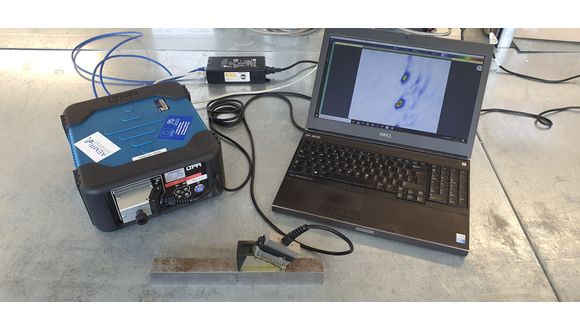 Peak NDT LTPA unit along with a transducer and laptop running TWI Crystal.  The interior of a calibration block containing side drilled holes is being imaged.