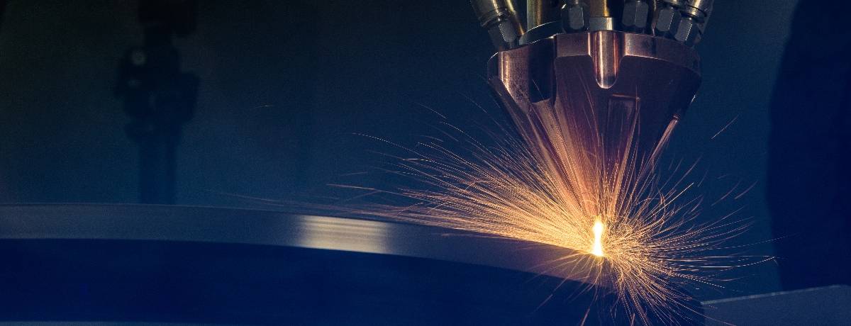 Laser metal deposition nozzle depositing metal with sparks at TWI Technology Centre Yorkshire
