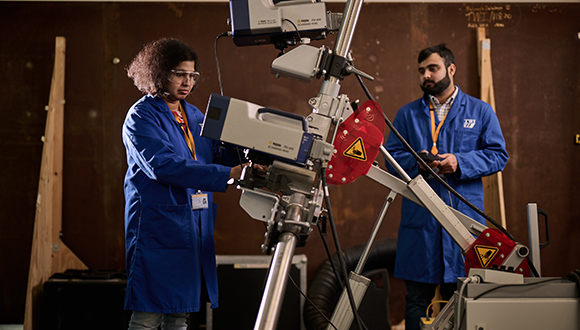 Thamasha Samarasinghe, working alongside fellow NSIRC student Shahryar Manzoor in the Brunel Innovation Centre (BIC) laboratory. Both BIC and BCC operate from laboratories at TWI Ltd, Cambridge. Photo: Lloyd's Register Foundation / Sam Barker Photographer 