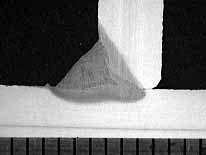 Fig.5. Transverse cross-section of laser hybrid weld showing large external fillet and narrow laser root. Scale in millimetres