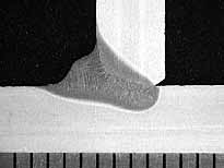 Fig.6. Transverse cross-section of laser-MAG hybrid weld showing reduced fillet and wider laser root. Scale in millimetres