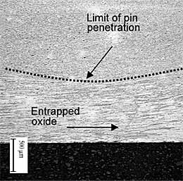 Fig.3. Weld T7 macro showing weld nugget structure (top) and coarse grain structure of the weld root (bottom). It can be observed that the pin penetration was ~0.8mm from the bottom surface during the process (leading to the creation of an entrapped oxide defect