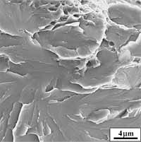 Fig.17b) Magnified view of the initiation area. The arrow indicates the likely initiation point, found in the immediate vicinity of microductility occurring at the grain-boundary 