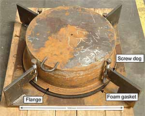 Fig.1. Enclosed dam attached to the plate that simulated the bottom of the hull of an FPSO. Each of the four screw dogs shown was attached by depositing a three-pass fillet weld on one side in the overhead position.