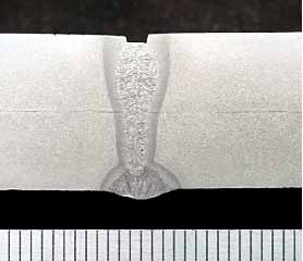 Fig.11. Section through pipe wall, showing internal MAG root run and 9.0kW autogenous laser fill made at 0.7m/min. Pipe grade API 1104 X70 14.3mm wall thickness (mm scale shown).