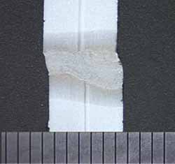 Fig.4. Cross section of saddle weld, showing high-low mismatch. Laser beam entry from the right. Scale in millimetres