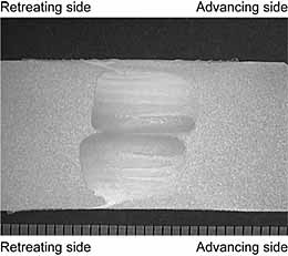 Fig.3. Macrosection of a dual-rotation stir double sided butt weld in 16 mm thick 5083-H111 aluminium alloy, at a welding speed of 3 mm/sec (180mm/min), using 584 revs for the probe and 219 revs for the shoulder. Double-sided weld passes were made in the opposite direction, with the first pass shown on top.