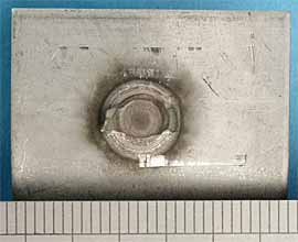 b) With controlled cooling of 10 cycles up-slope, 6.1kA post heating current and 30 cycles post heat time - showing partial plug failure