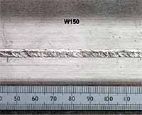 Fig. 3. Weld produced with 3.1kW laser power at workpiece, Ø0.6mm focus spot, -1mm focus position, 1.4m/min welding speed, 1.25m/min wire feed speed (Ø1.2mm ER2319): 3a) Top weld bead profile