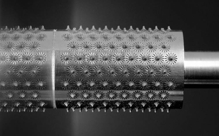 Figure 10. An array of 170 nominally identical Surfi-Sculpt features produced on 316 stainless steel bar