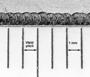 3b) plan view showing series of overlapping spots along edge of package lid to form continuous seal