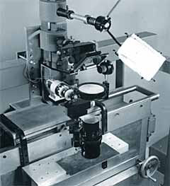 Fig.3. Experimental arrangement used in the early cutting experiments, showing beam stop, mirror, lens, pressure chamber, nozzle and sample