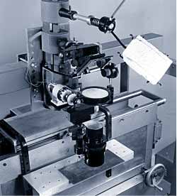 Fig.3. Experimental arrangement used in the early cutting experiments, showing beam stop, mirror, lens, pressure chamber, nozzle and sample.