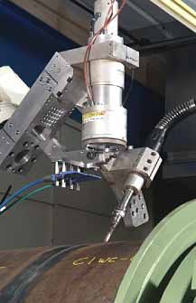 Fig.4. Nd:YAG laser - MAG hybrid process being developed for land pipeline girth welding Fig.4a) welding head