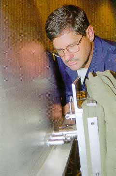 b) The friction plug welding apparatus in action.