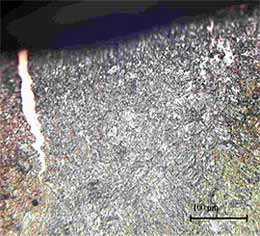 Fig.7. Zinc filled crack in the outer surface of the spot weld (electrode indentation) due to liquid metal penetration. Crack depth 0.2mm