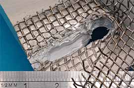  Fig.5. Transition joint between stainless steel mesh and aluminium sheets a) Weld region pull-out with embedded and part ruptured mesh 