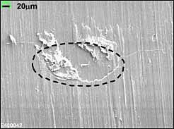 b) SEM micrograph of replica, showing crack TA-3 in Specimen 03 (at N=529,230 cycles, 2c=0.33mm). The area where the crack initiated from is circled;