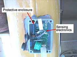 Fig. 2. Typical sensor installation prior to sealing the protective enclosure (the sensor shim is beneath the sensing electronics) 