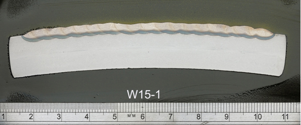 Macrosections taken through the samples relating to test weld W15. Scale ruler shown: (a) First layer (W15-1);