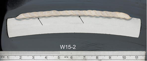 (b) Two layers (W15-2) - arrows indicate the limit of the 2nd layer HAZ (darker);