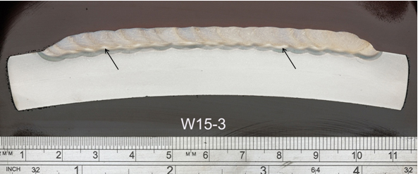 (c) Three layers (W15-3) - arrows indicate the limit of the 3rd layer HAZ (lighter).