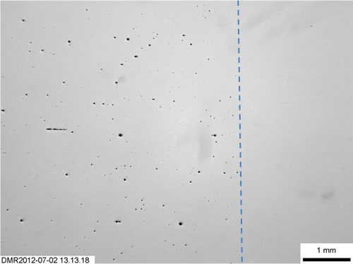 Figure 17. Un-etched parent metal showing the size and dispersion of non-metallic inclusions, with the dotted line indicating the fusion line, with weld metal to the right