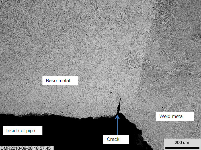 (a) Weld W1, showing a 0.14mm deep crack at the toe of the weld root bead