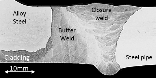 Figure 2 - A photomacrograph of a cross-section of a commercially produced 8630-625 dissimilar weld (8630 hub forging shown on the left).