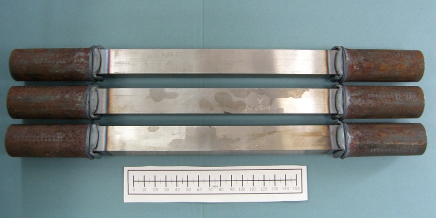 Figure 15 Round bar friction welded onto each end of the SENT square section blanks, prior to notching of the specimen and machining threaded ends.