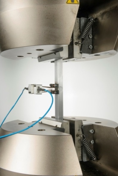 Figure 1 SENT test specimen of square cross section instrumented with a double clip gauge ready for test under clamped loading at ambient temperature